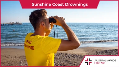 Male lifeguard patrolling beach